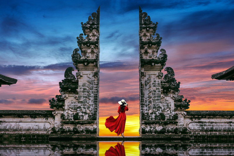 Young,Woman,Standing,In,Temple,Gates,At,Lempuyang,Luhur,Temple